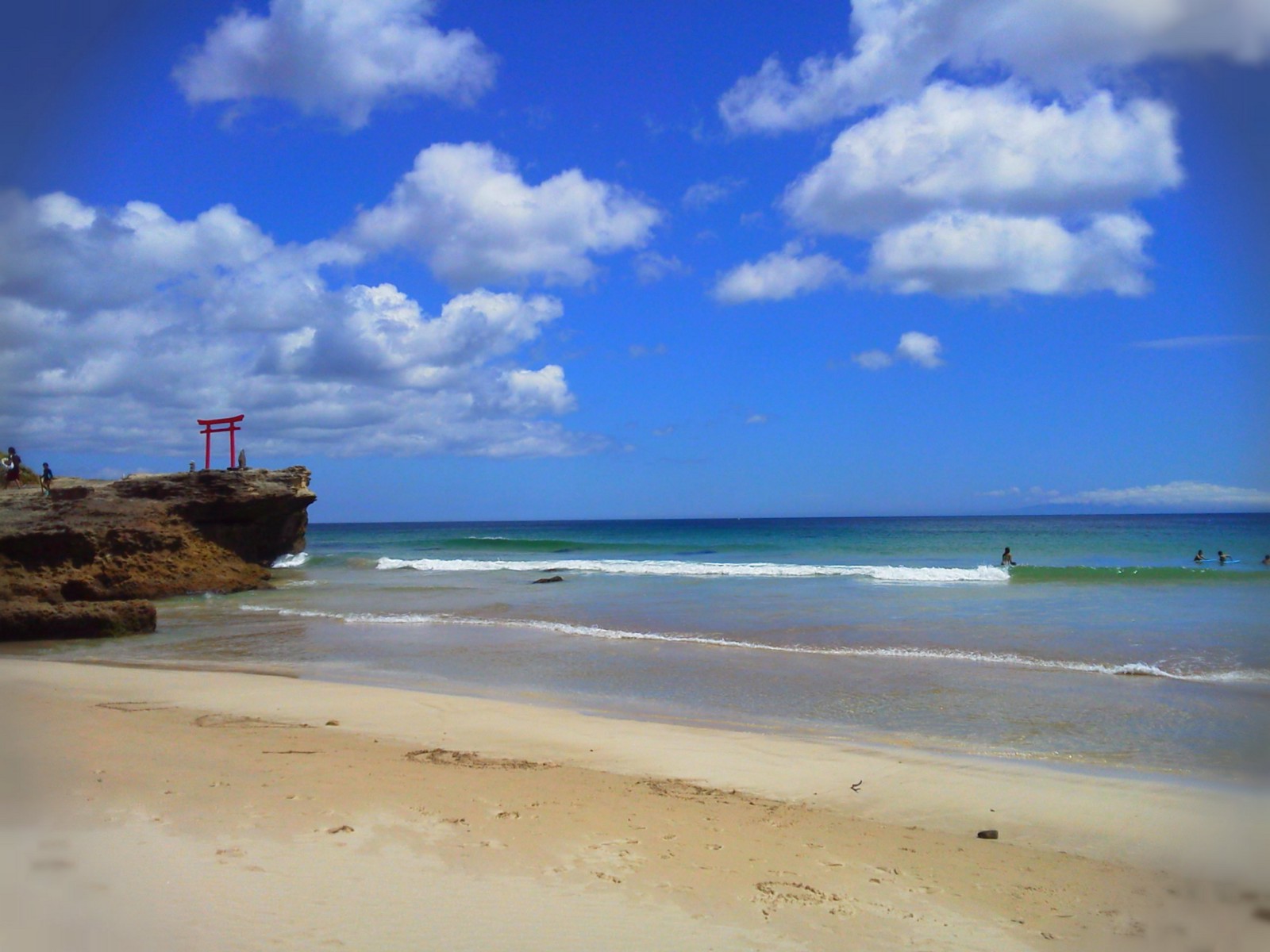 The beautiful Shirahama Beach with the red torii gate and the blue sky