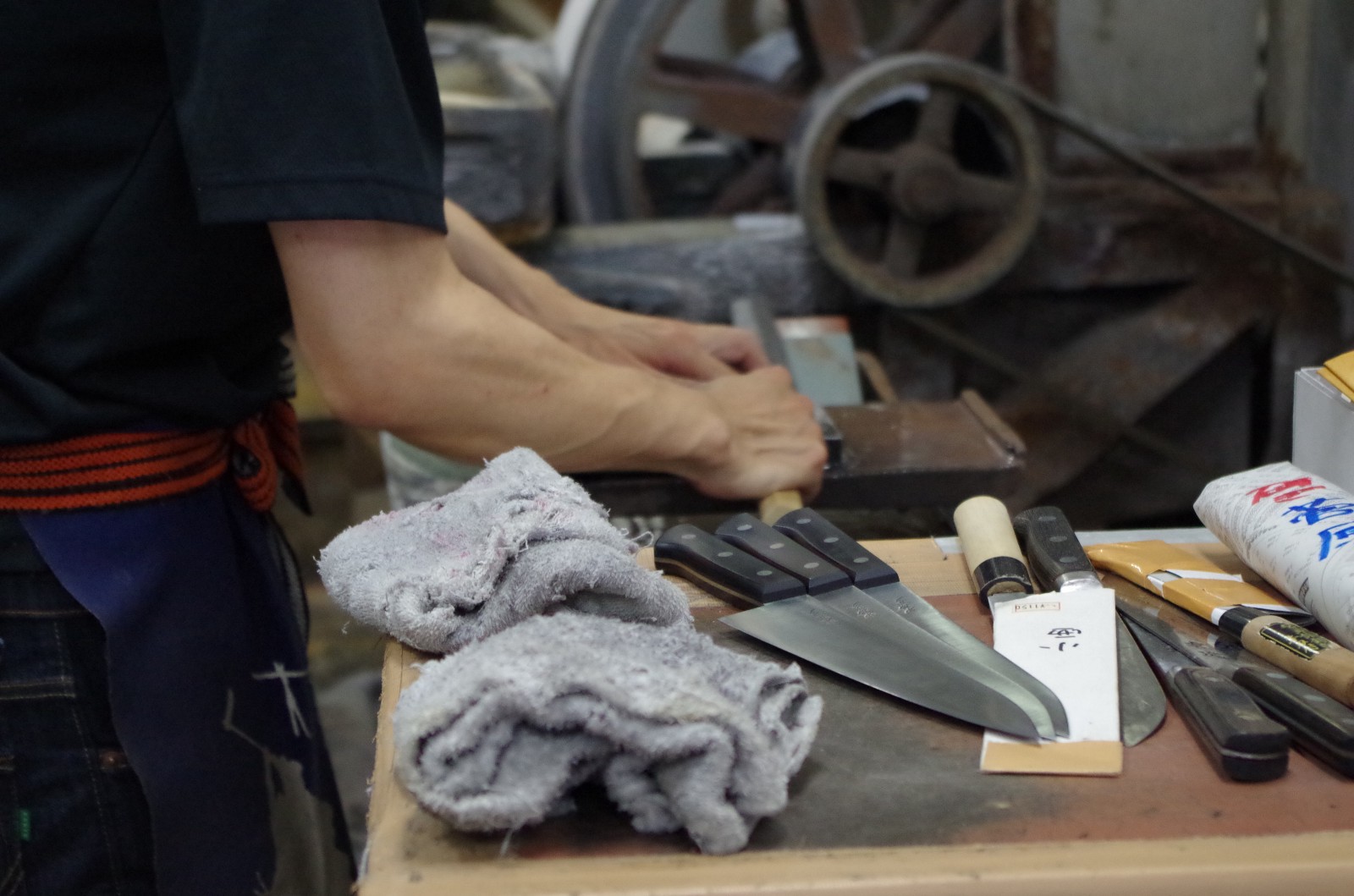 Japanese swordsmith sharpening knives