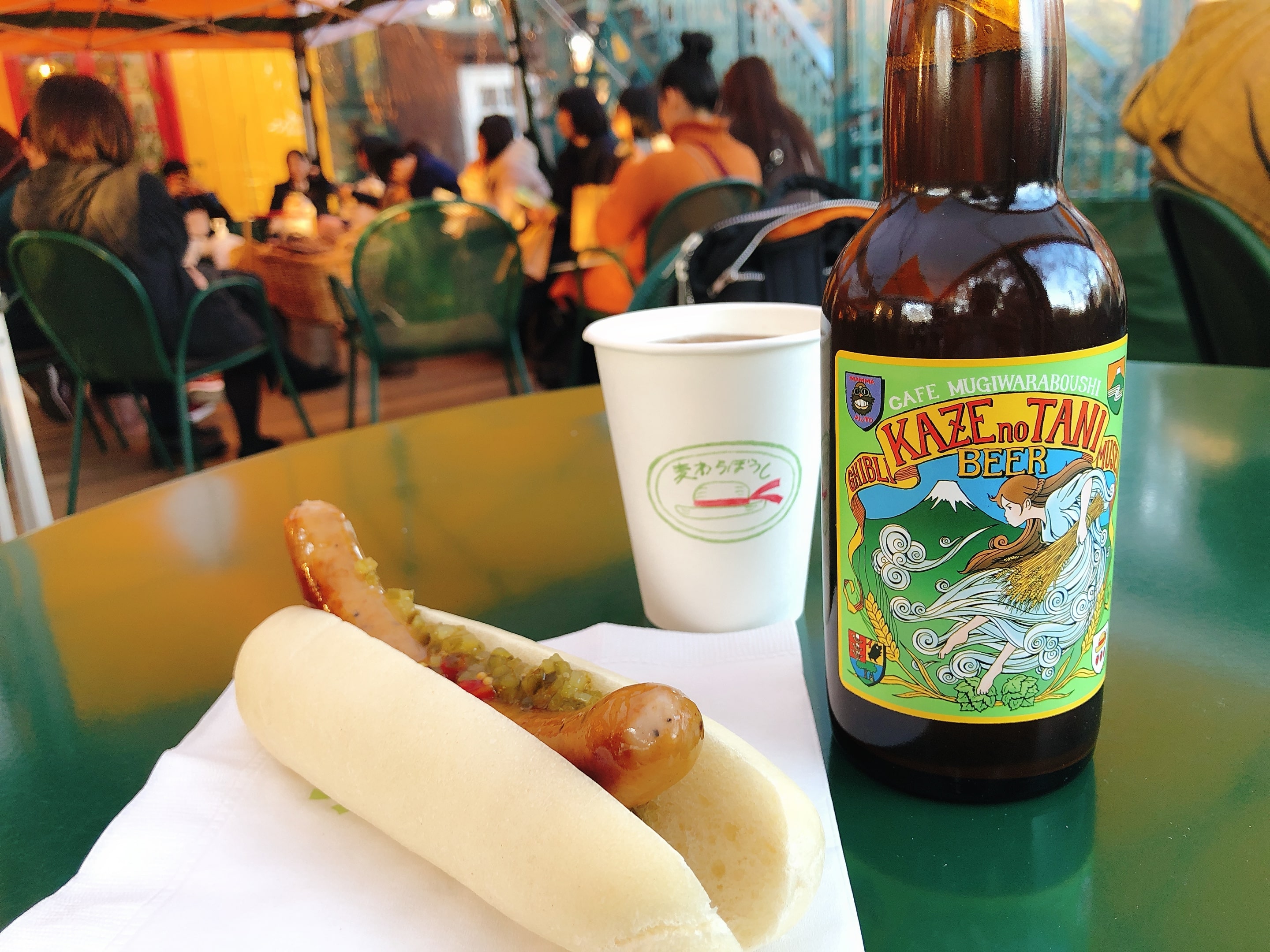 A hotdog and a bottle of beer at Café Deck Area