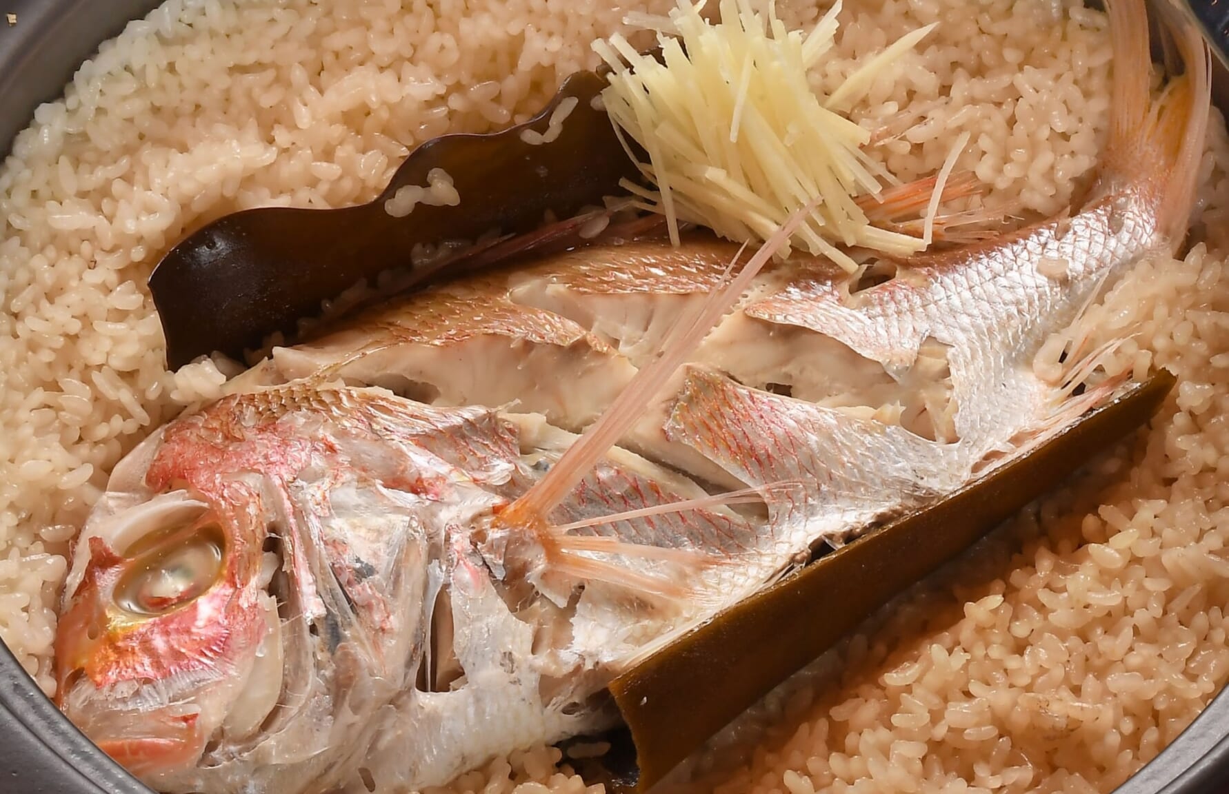 Taimeshi, an entire sea bream on top of a bowl of rice