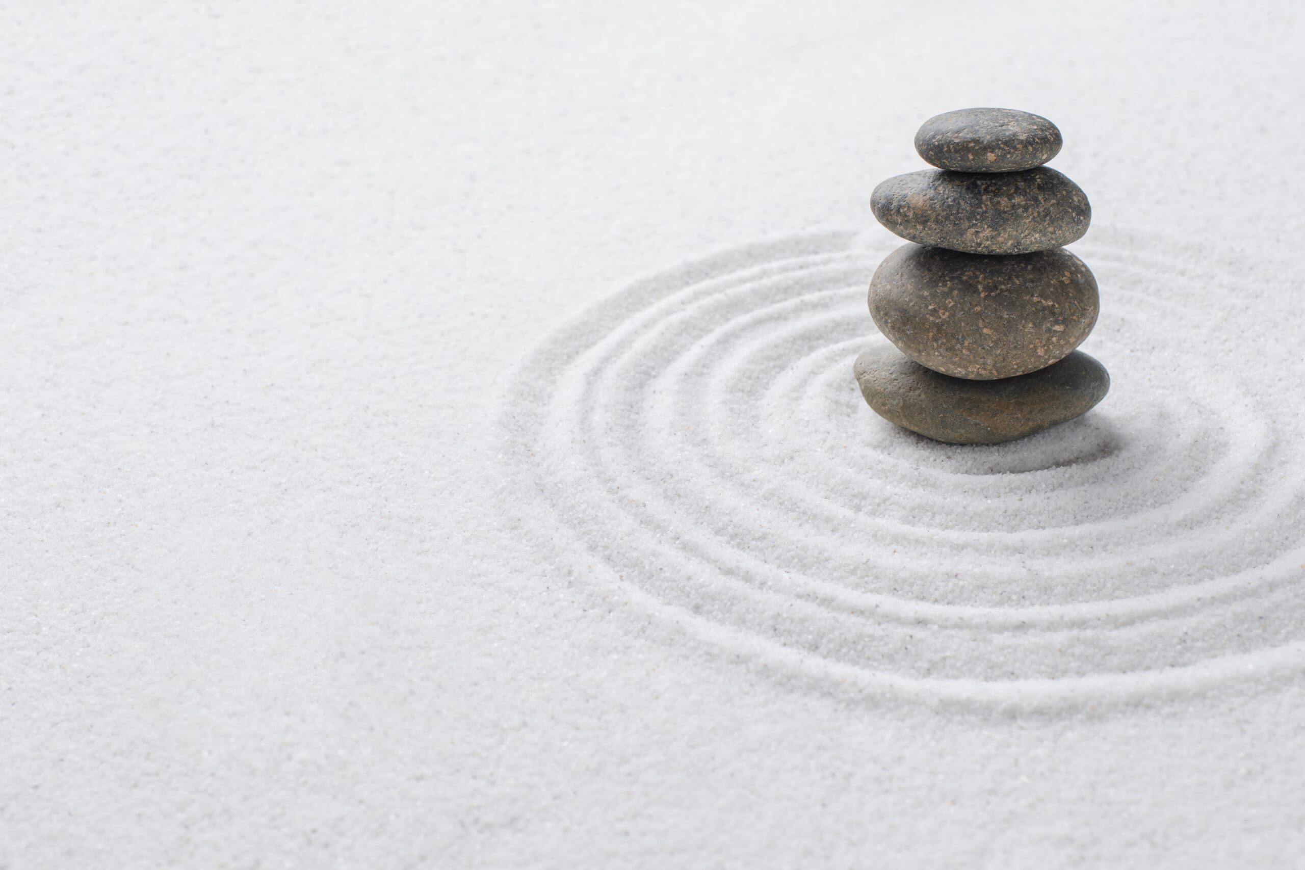 stacked-zen-stones-sand-background-art-balance-concept-min