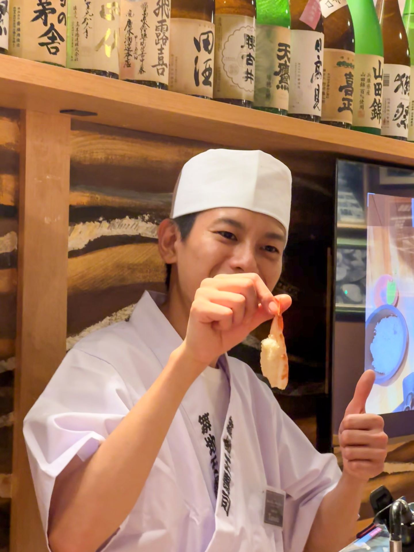 Chef explaining how to test properly done shrimp nigiri at Sushi Nigiri Experience Asakusa Dojo