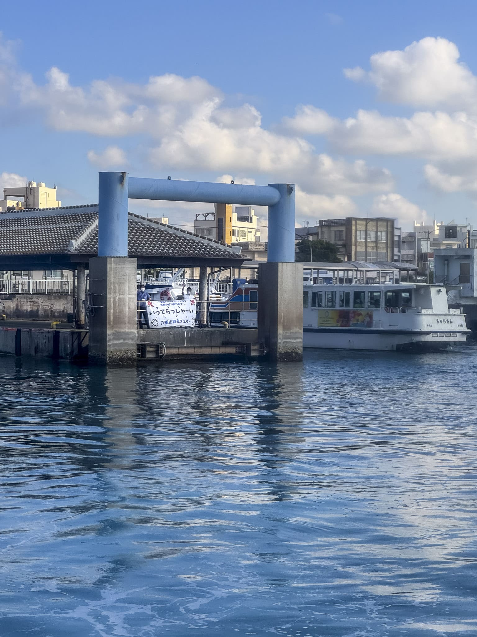 Yayama Kanko Ferry waving goodbye to the ferry leaving Ishigaki Port